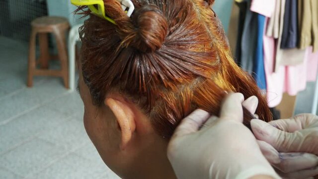 Dyeing hair and make a treatment for a blonde women at home or salon. Local coloring hair concept. 