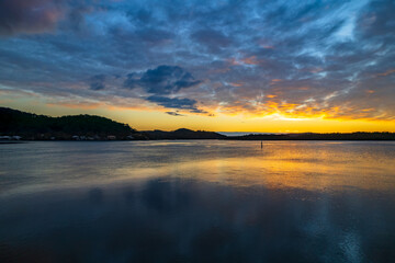 Sunrise waterscape and reflections with clouds