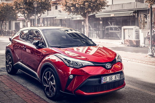 Alanya, Turkey &ndash; April 12 2021:  red Toyota C-HR  parked  on the street in city against the backdrop of a   buildung,  shops, trees
