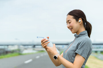 運動の途中、ドリンクを飲む女性