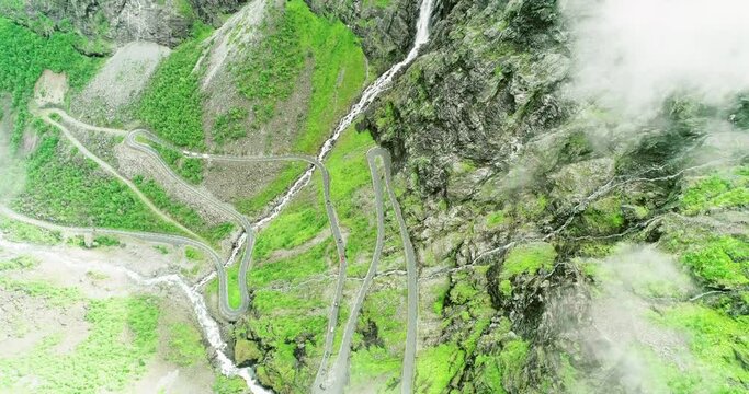 Curved hairpin turns on Trolls road down lush mountain side - aerial bird´s-eye
