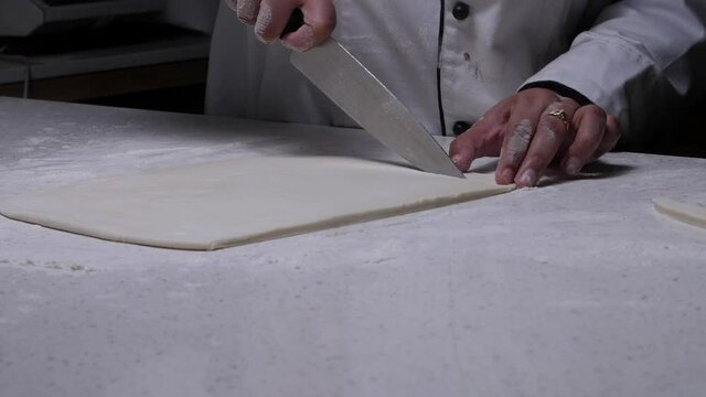 cutting dough for making khari.
