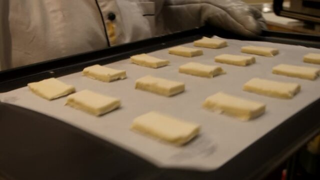putting khari  in the oven for baked