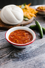 Traditional mexican red sauce in white bowl in mexican restaurant