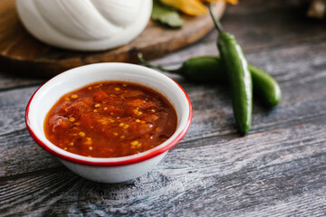 Traditional mexican red sauce in white bowl in mexican restaurant