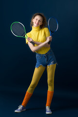 Shot of pretty girl tennis player holding rackets