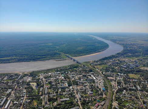 Aerial view of the city, Vyatka river and railway bridge (Kotelnich, Kirov region, Russia)