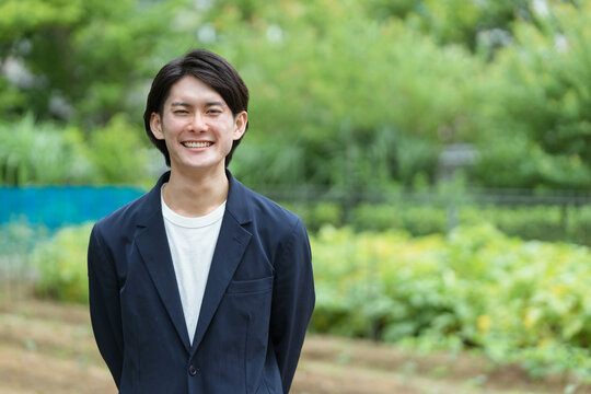 畑を管理する若い男性・新しい農業