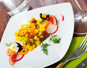 Image of deliciously tartar of raw tuna with avocado, mango and greens