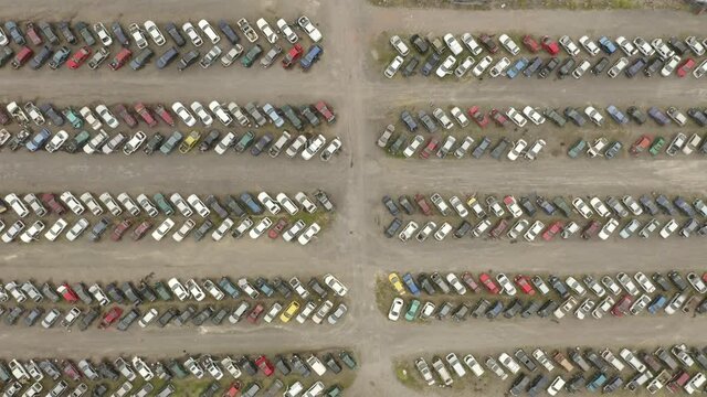 Full car wreckers with broken down vehicles perspective from aerial view.
