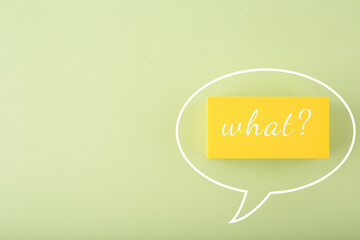 White speech bubble with what question on bright green background with copy space. Minimal, modern concept of emotions expression and being surprised or exited