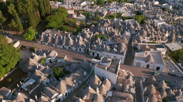 Aerial view of trulli of alberobello town in Italy. drone fly over old town buildings at sunrise