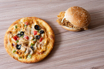 pizza and burger combination on wooden background