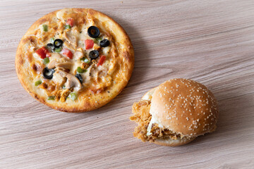 pizza and burger combination on wooden background