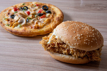 pizza and burger combination on wooden background