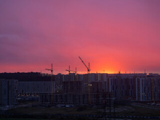 Fototapeta na wymiar dramatic sunset over a construction site