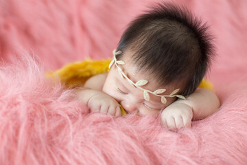A cute newborn boy wearing a headband and small angle wing sleeping on a pink soft blanket, Infant, babyhood concept and copy space - Image