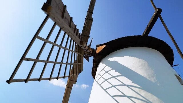 The wooden structure of the blade of a windmill in Hungary with clear, blue sky