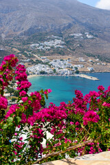 Panorama view of Aegiali and Lagada village framed with bougainvillea flowers ,  in  Amorgos island  Greece