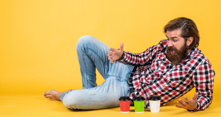 Magic look. man drink hot tea from paper cup. good morning. energetic warm take away beverage. need some coffee to go for inspiration. surprised bearded man drinking morning coffee