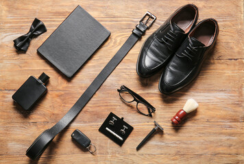 Different stylish male accessories on wooden table