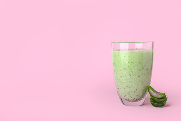 Glass of healthy aloe juice on color background