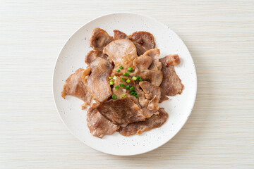 grilled pork neck sliced on plate