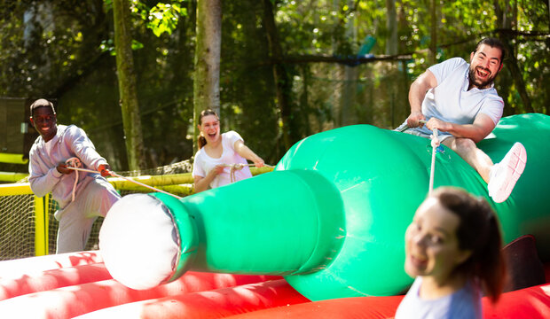 Funny attraction with a huge inflatable bottle in an amusement park. High quality photo