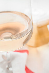 Glass of delicious wine on white background, closeup