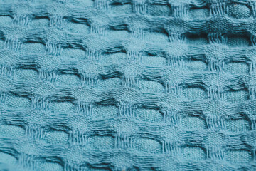 Texture of blue knitted fabric as background, closeup