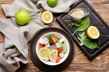 Plate with healthy salad on wooden background