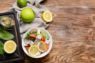 Obraz na płótnie Canvas Plate with healthy salad on wooden background