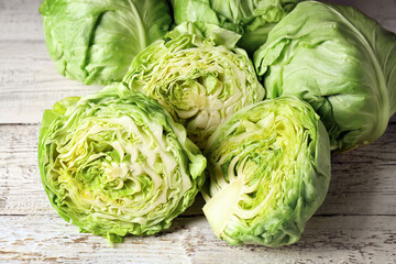 Fresh cabbage on light wooden table