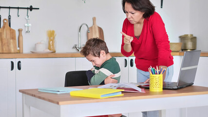 angry serious mum lecturing lazy unmotivated schoolboy, children education problem, parent and child conflict. Stressed mother and son frustrated over failure homework.