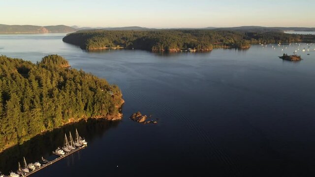 Cinematic 4K aerial drone clip of Orcas Island, sailboats and yachts anchored in Blind Bay on Shaw Island in the San Juan Islands in Washington