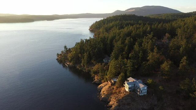Cinematic 4K aerial drone sunset shot of Orcas Island, Turtleback Mountain, Orcas Village by the Harney Channel in the San Juan Islands in Washington
