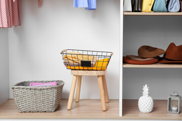 Modern organizers with clothes in wardrobe