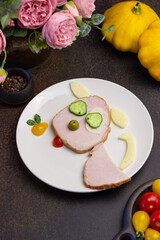 Creative idea for a children's breakfast, a dog made of meat, cheese and vegetables. food art idea. Children, holidays, summer, autumn, the concept of healthy, proper nutrition. Free space for text. C