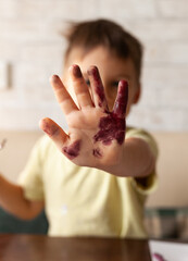 the child draws with scribbles on a white sheet of paper. child development, art development, child development, artistic development of the child concept.