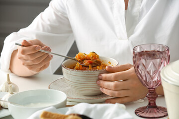 Obraz na płótnie Canvas Woman eating delicious borscht at table, closeup