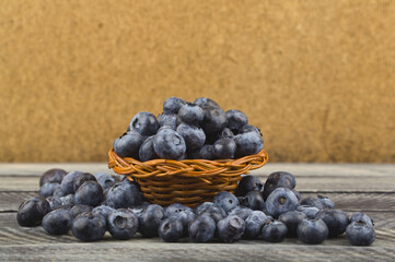 Juicy fresh blueberries on a wooden background.