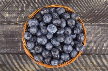 Juicy fresh blueberries on a wooden background.
