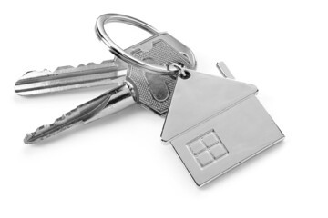 Keys with house shape keychain on white background