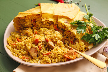 Plate with tasty Shah Pilaf on color wooden background, closeup