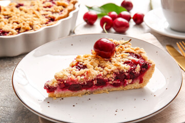 Plate with piece of tasty cherry pie on light background, closeup