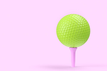 Green golf ball on tee isolated on pink background