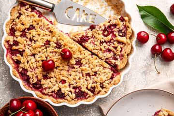 Baking dish with tasty cherry pie on light background