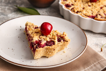 Plate with piece of tasty cherry pie on light background, closeup