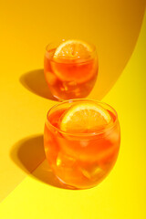 Glasses of Aperol spritz cocktail on color background