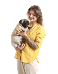 Young woman holding cute pug dog on white background